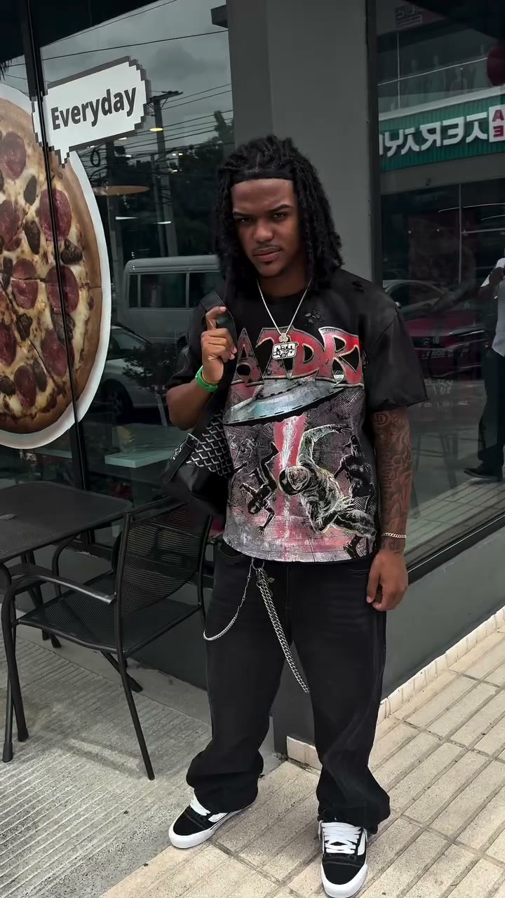 Front of the Drip G tee worn on the block: pink artwork on black